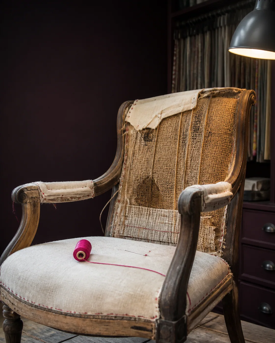 Fauteuil en cours de restauration dans un atelier de tapisserie